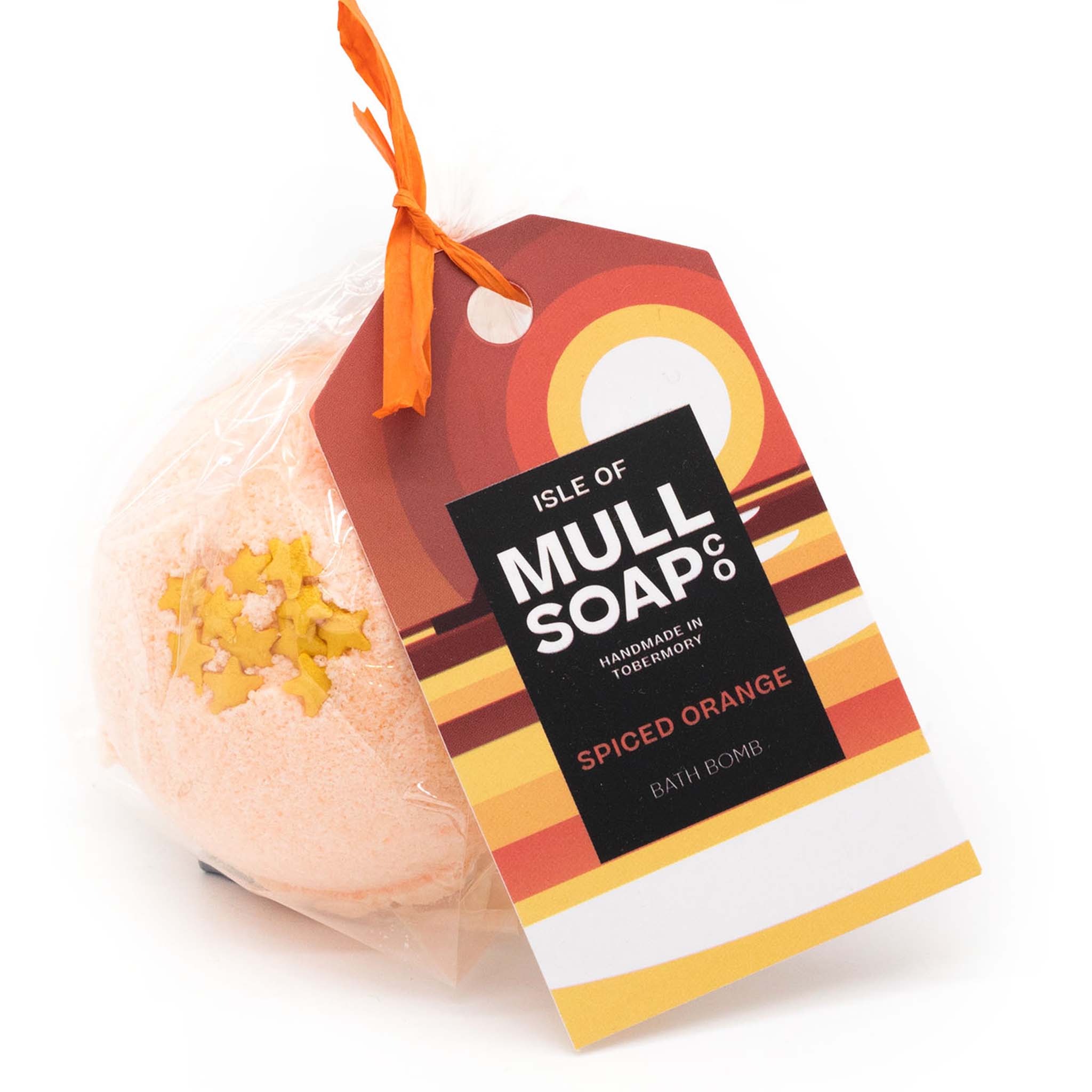 orange coloured round spiced orange bath bomb with star decoration presented as a gift in a bag with coloured tag and bow. Handmade by the Isle of Mull soap co in Tobermory, Scotland.