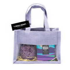 A purple jute bag gift set with front window. Contains a purple leaf cut out ceramic burner and 2 Mull heather scented soy wax melt snap bars made by the Isle of Mull soap co in Tobermory. contains packing shred and handles tied with a black tag.