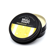 Prosecco lip balm in a black tin with colourful label. vegan lip balm handmade in Tobermory by the Isle of Mull soap co.