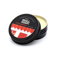 strawberry lip balm in a black tin with colourful label. vegan lip balm handmade in Tobermory by the Isle of Mull soap co.