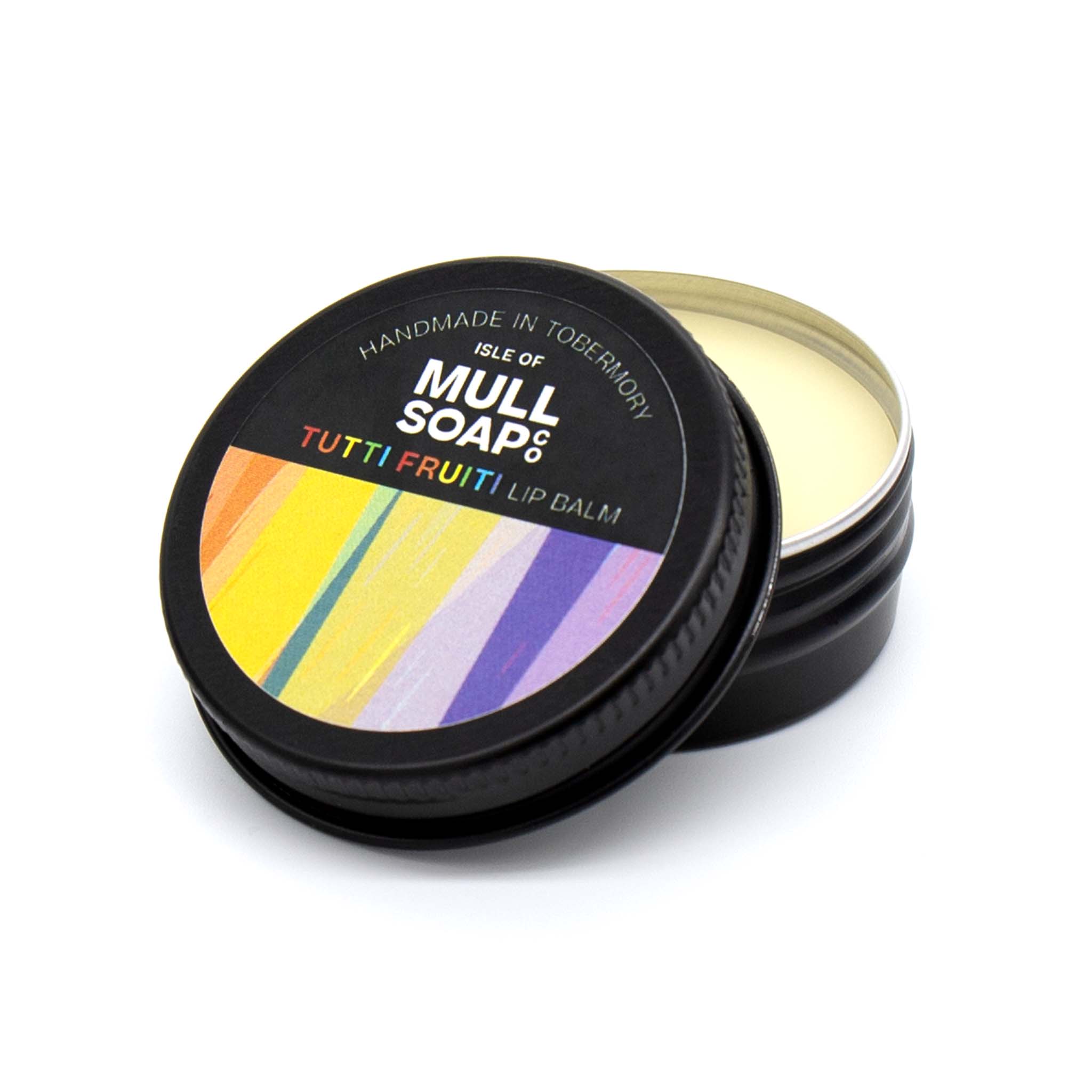 tutti fruiti lip balm in a black tin with colourful label. vegan lip balm handmade in Tobermory by the Isle of Mull soap co.