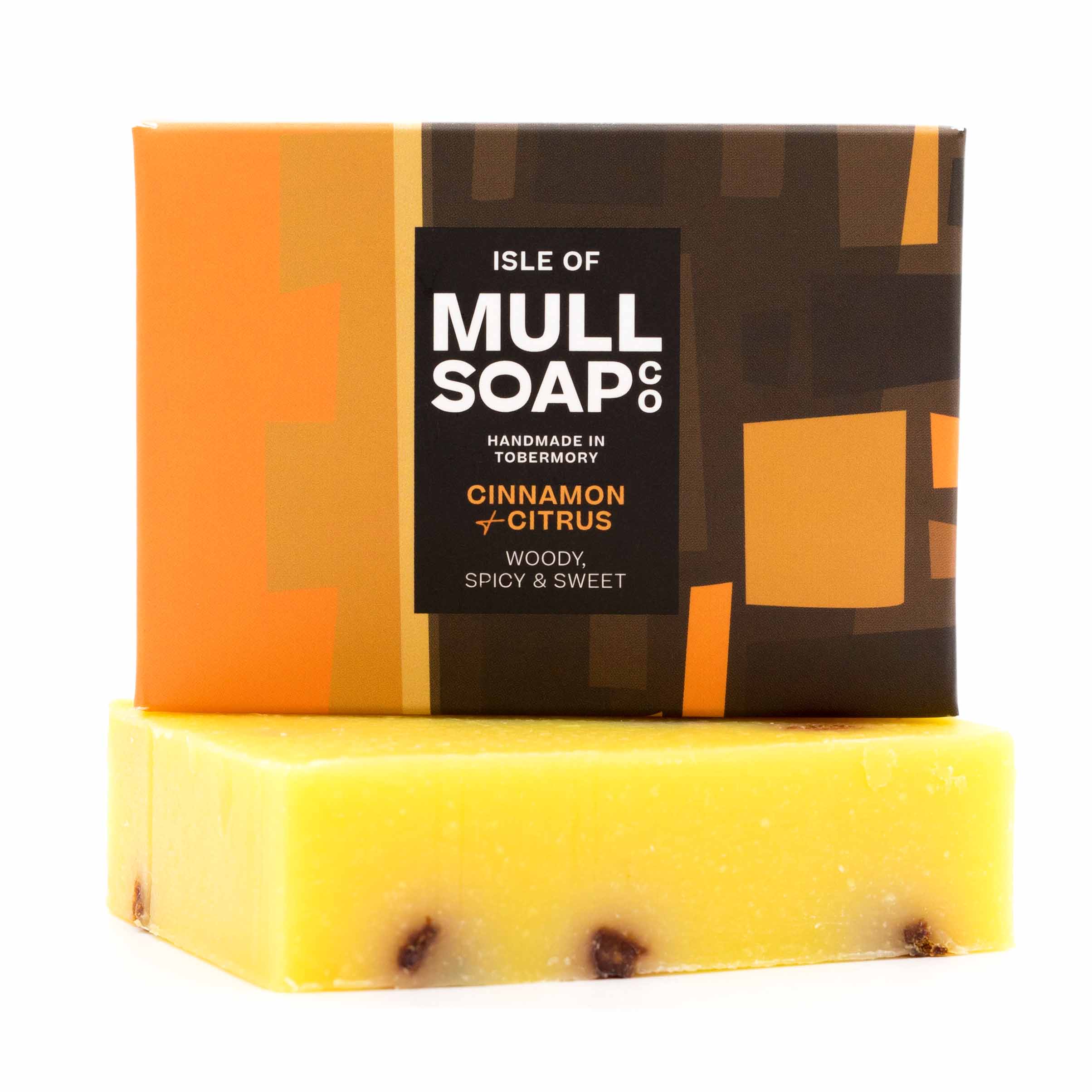 a cinnamon and citrus soap box sitting on the soap bar. The box is a a brown and orange design. The soap is described as woody, spicy and sweet. Handmade in Tobermory by the Isle of Mull soap co.