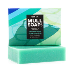 a double mint super scrub box sitting on top of the blue soap bar. The box is a blue and green design. The soap is described as very scrubby and very minty! Handmade in Tobermory by the Isle of Mull soap co.
