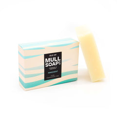 an innocent pure fragrance free soap box sitting next to the soap bar. The box is waves of white and pale blue green.  Handmade in Tobermory by the Isle of Mull soap co.