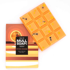 A bright orange Spiced orange scented soy wax melt snap bar with gold stars and cloves sprinkled in. Handmade in Tobermory by the Isle of Mull Soap Co.