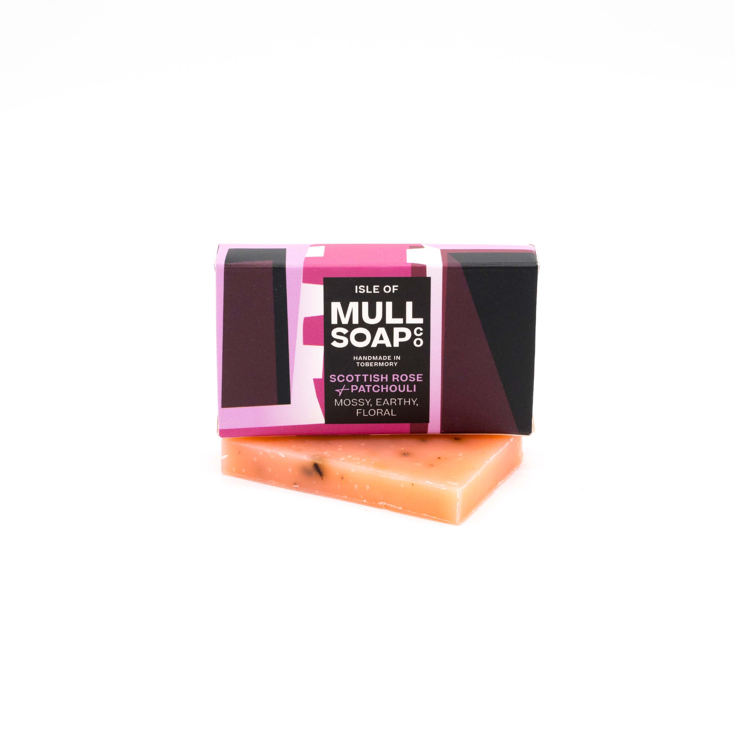 A Scottish rose and patchouli mini soap box sitting on a mini pink soap bar. Soap described as mossy, early and floral. Handmade natural soap made by the isle of mull soap co in Tobermory.