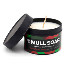 A black tin and lid with red and green funky label. Christmas spice soy candle handmade in Tobermory by the Isle of Mull Soap Co