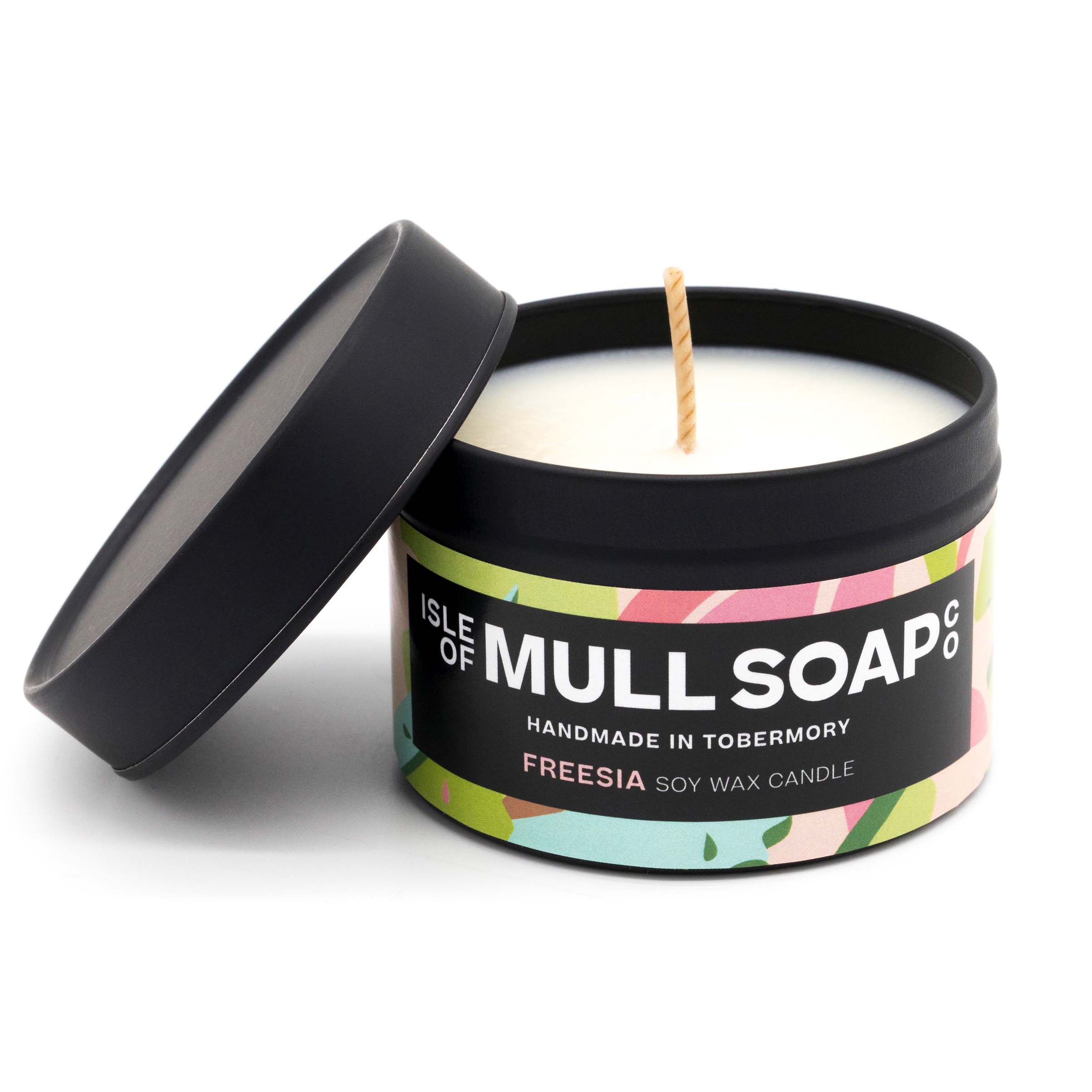 A black tin and lid with pink and green floral label. freesis soy candle handmade in Tobermory by the Isle of Mull Soap Co