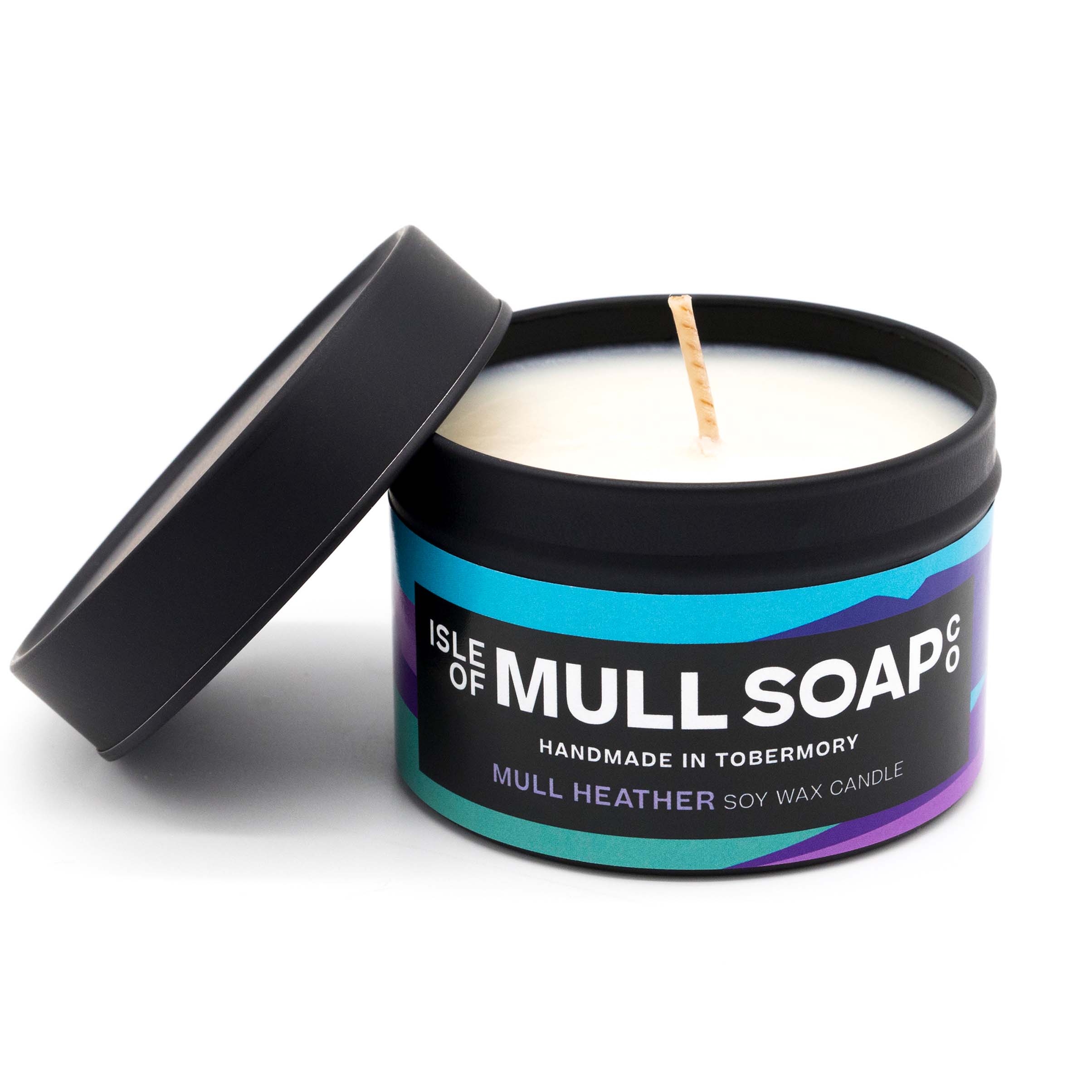 A black tin and lid with purple colourful label. mull heather soy wax candle handmade in Tobermory by the Isle of Mull Soap Co