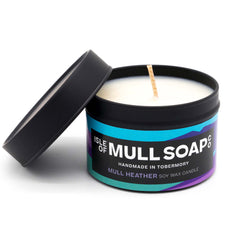 A black tin and lid with purple colourful label. mull heather soy wax candle handmade in Tobermory by the Isle of Mull Soap Co